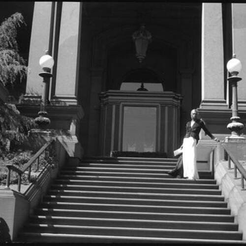 Sylvester standing on steps of Flood Mansion