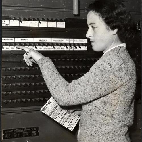 [Stella Tackney demonstrates how the voting machine operates]