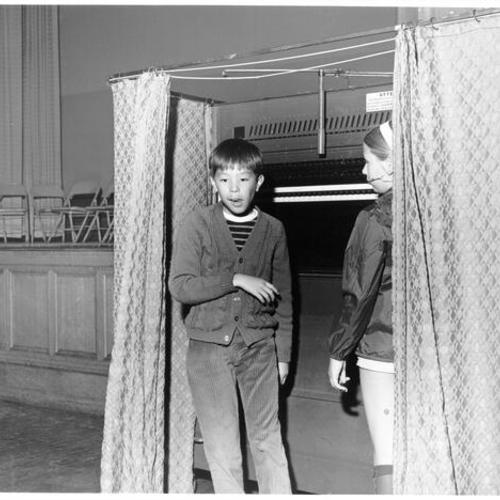 [Students in a voting booth at Lafayette School]
