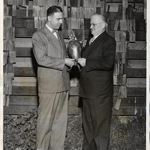 [Robert Di Giorgio and Mayor Elmer E. Robinson holding a Columbia Park Boys' Club trophy]