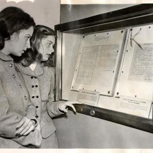 [Nancy Walker and Barbara Hendrickson looking at documents in a display case on the Freedom Train]