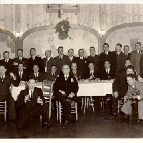 [Group of men posing for a picture in a restaurant in Visitacion Valley]