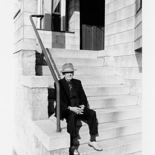 [Haight Ashbury - elder man sitting on the front steps of a house]