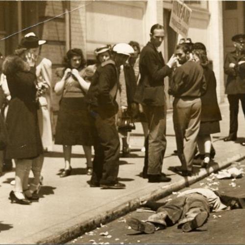 [John A. Gomez lying in street after collapsing on picket line at the Euclid Candy Company]