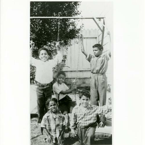 [Ernestine's children, family and friends playing in her backyard]