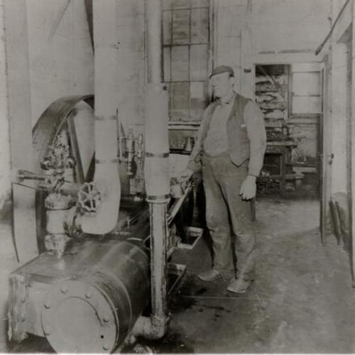 [Engineer Fred Wilhening in engine room of the Golden Gate Distillery on Fillmore Street]