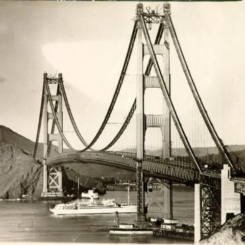 [View of the Golden Gate Bridge while under construction, showing unidentified ship entering San Francisco Bay]