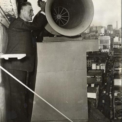 [Harvey Vesser, State electrician, on top of tower with ferry siren]
