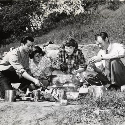 [San Francisco State College Instructor Victor York teaching "outdoor skills" to three students]