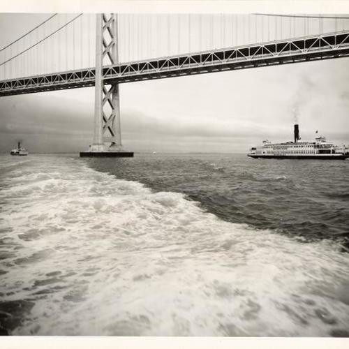 [San Francisco-Oakland Bay Bridge stretches above the ferryboat "Berkeley"]