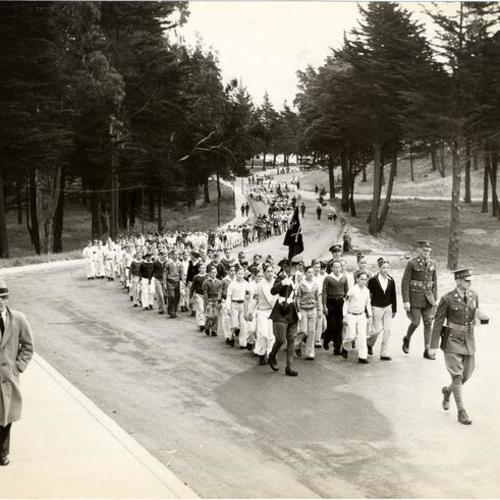 [Members of the San Francisco Junior Traffic Patrol marching through the Presidio]
