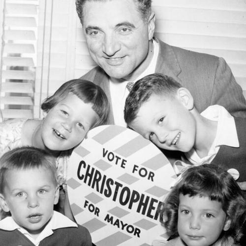 [George Christopher sitting with four children during one of his  mayoral campaigns]