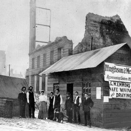 [William L. Hughson and others standing in front of shack from which he did business for several weeks  following the 1906 earthquake]