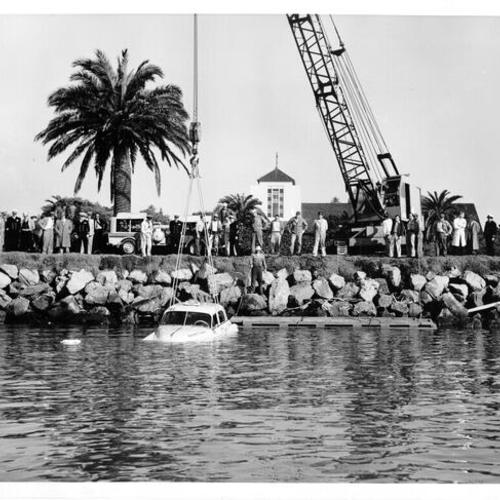 [Treasure Island workers pull car out of bay water]