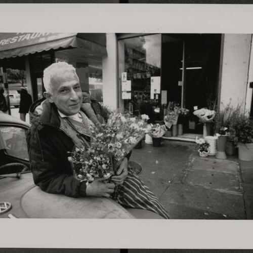 Massis Bedayan with his 1966 Volkswagen Beetle outside his flower shop at Larkin and Eddy Streets