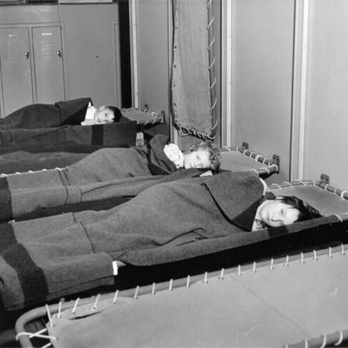 [Children resting on cots at Sunshine Orthopedic School]