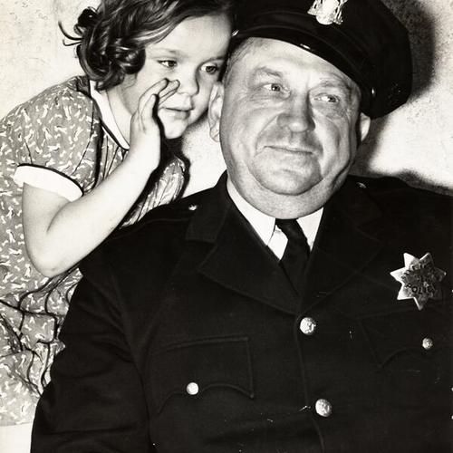 [Officer Gus Wuth with youngster Patricia Shea]