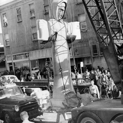 [Statue of Saint Francis of Assisi being moved from the entrance of the St. Francis Church to a temporary location in Oakland]
