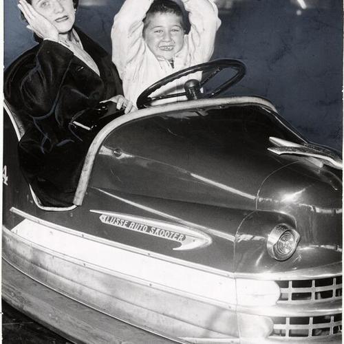 [Mrs. Samuel Duden and her son Ira on a ride at Playland at the Beach]