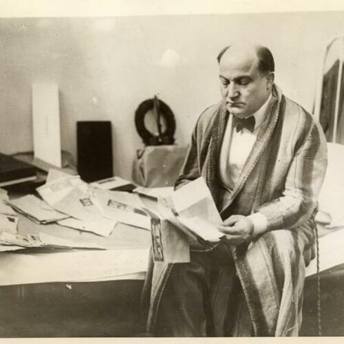 George Remus reading telegrams from his jail cell