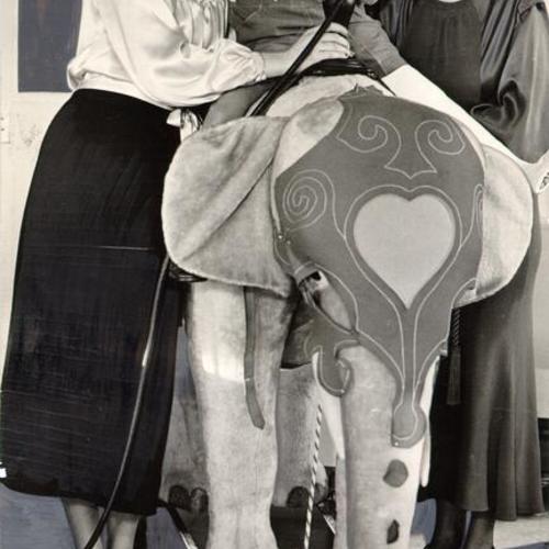 [Georgia Mangan and Helen Hobreacht posing with a patient at the Shriners' Hospital for Crippled Children]