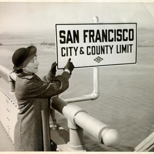 [Ann Brown dedicating a sign on the Bay Bridge showing the division point between San Francisco and Oakland]