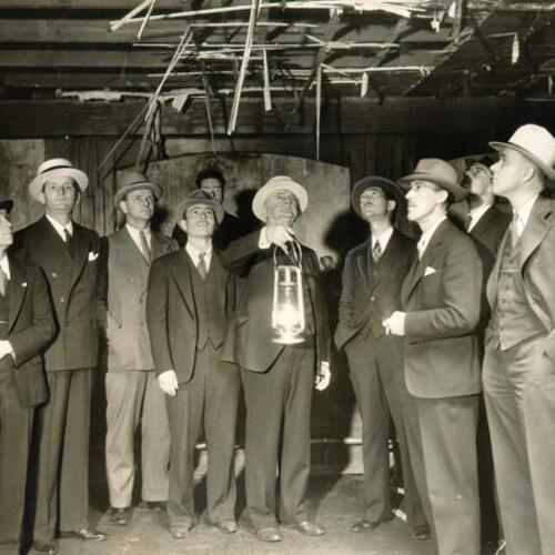 [Group of men inspecting the Shamrock Cafe, on 560 Geary, for arson]
