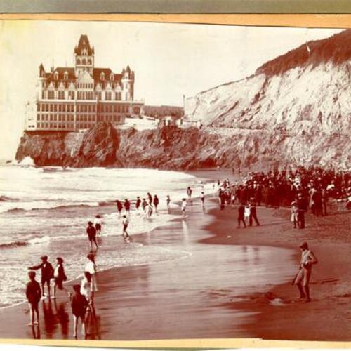 [Crowds of people congregating on Ocean Beach across from the Cliff House]