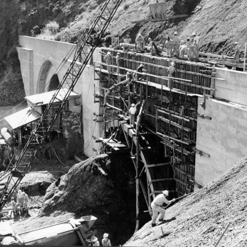 [Workmen pouring concrete for Waldo Tunnel portal and arch]