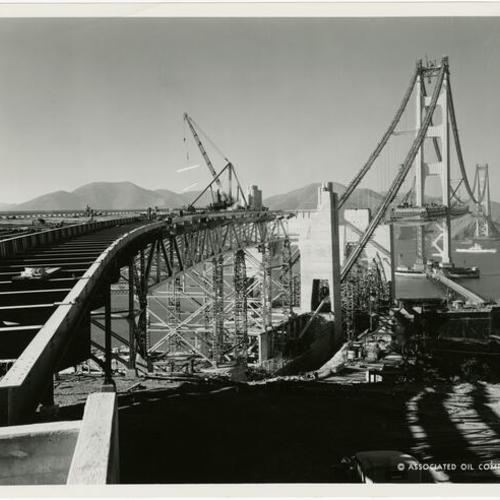 [Golden Gate Bridge deck being placed by workmen]