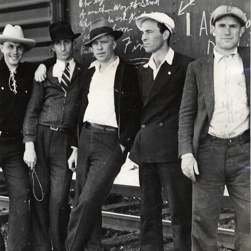 [Members of the Warehousemen's Union on picket duty at "hot" railroad car]