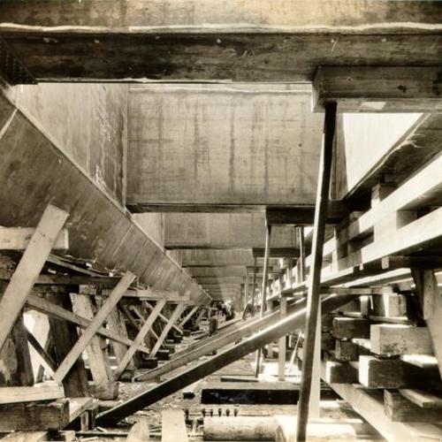 [View of the underside of a large bridge caisson used during construction of the San Francisco-Oakland Bay Bridge]
