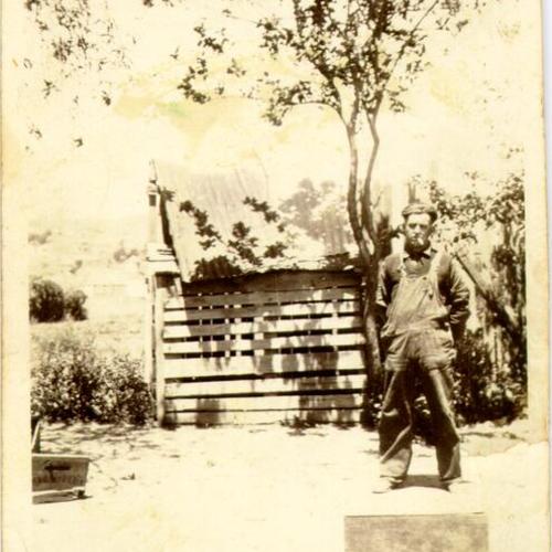 [Man standing in a garden in Visitacion Valley]