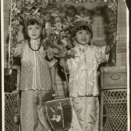 [Lorraine Louie and Ruby Law dressed in fancy costume for the Chinese New Year Festival]