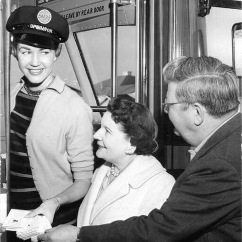 [Marge Peffer handing out Muni timetables to Dorothy Lloyd and William Als]