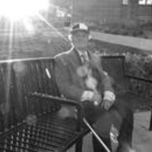 Elderly man enjoys the sun outside the library