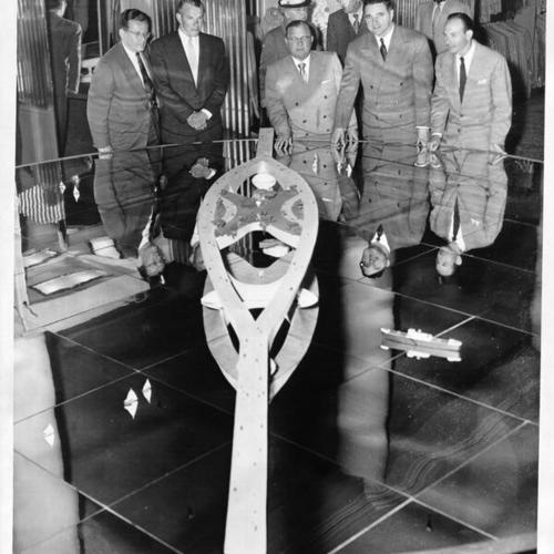 [Henry Alexander, Arthur Hoggard, Jr., Dewey Mead, George Christopher, and Aaron G. Green being photographed with model of proposed "Butterfly Bridge" designed by Frank Lloyd Wright]