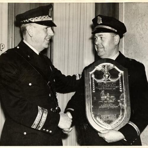 [Capt. Bernard J. McDonald (right) receiving award from Police Chief William J. Quinn]