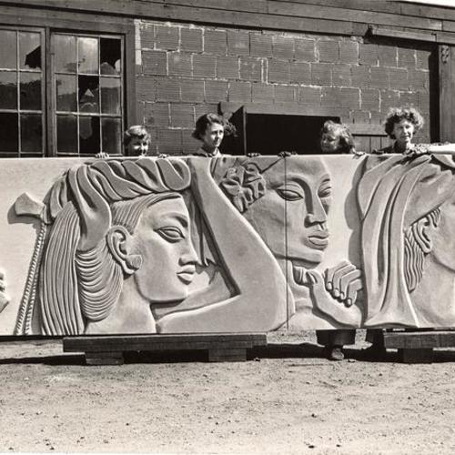 [Eleanor Pickersgill, assistant, and artists Margaret, Helen and Esther Bruton, are shown with sections of the mural 'Peacemakers' that will decorate the West walls of the Court of Pacifica, Golden Gate International Exposition on Treasure Island]