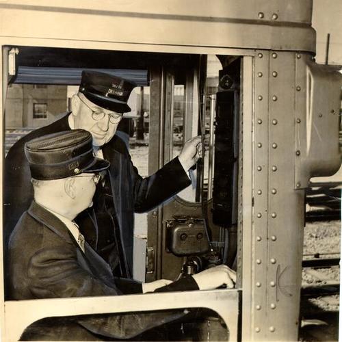 [W. C. Smith instructing Jack Orr on how to operate a San Francisco-Oakland Bay Bridge train]
