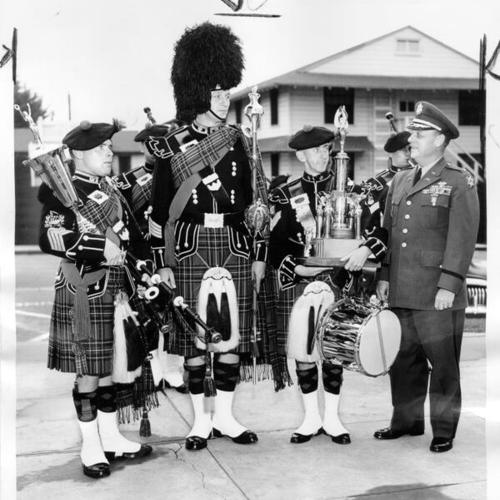 [Members of the Sixth Army Pipe Band with trophies won at competitions in Portland and Seattle]