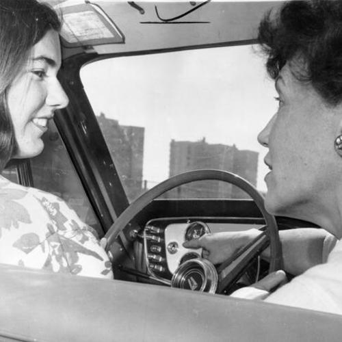 [Student Pat Lennon with teacher Caryl Corey during a driving lesson at Lowell High School]