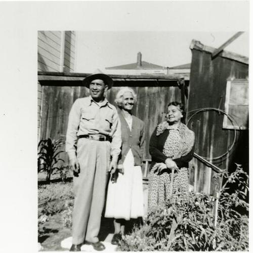 [Portrait of family and friend in backyard]