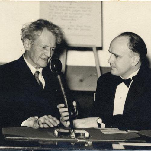 [Photographer Arnold Genthe (left) with unknown person (right) at book signing]