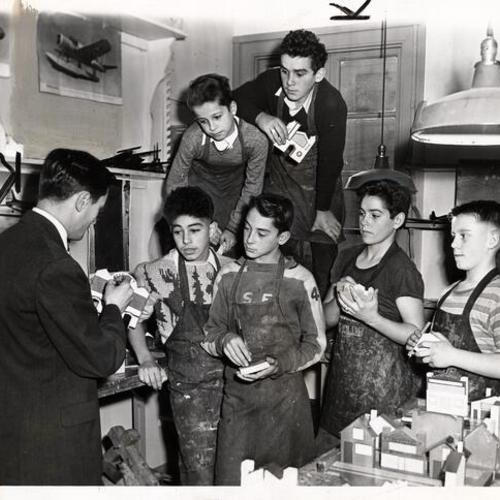 [Boys Club members and instructor at a craft workshop]