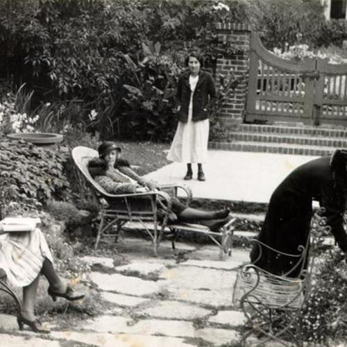 [Four women in a garden at the Ladies' Protection & Relief Society]