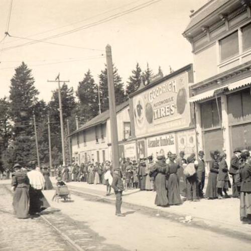 [Refugees standing in a line on Page Street near Stanyan]