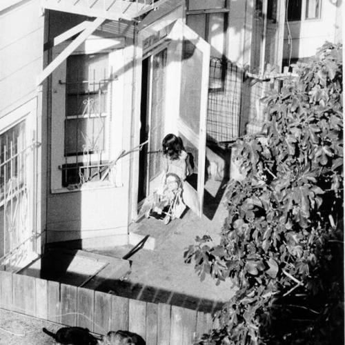[Young girl in the backyard of a Haight Ashbury home]