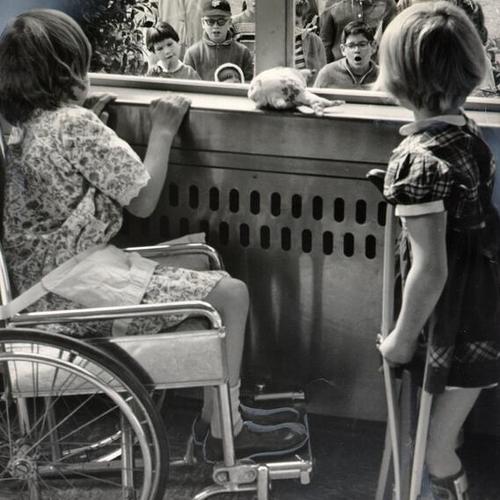 [Ambulatory members of the Recreation Center for the Handicapped, Inc., singing to hospital-bound children at the Shrine Hospital for Crippled Children]