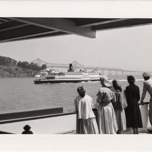 [Passengers on the ferryboat "Berkeley" watch another ferry sail by]